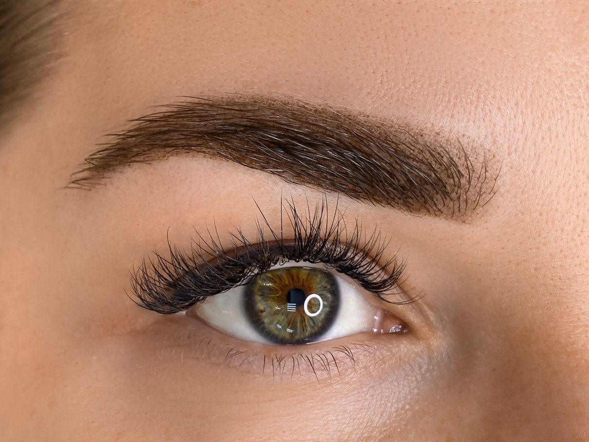 womans beautiful brow close up, natural make up and tattoo permanent